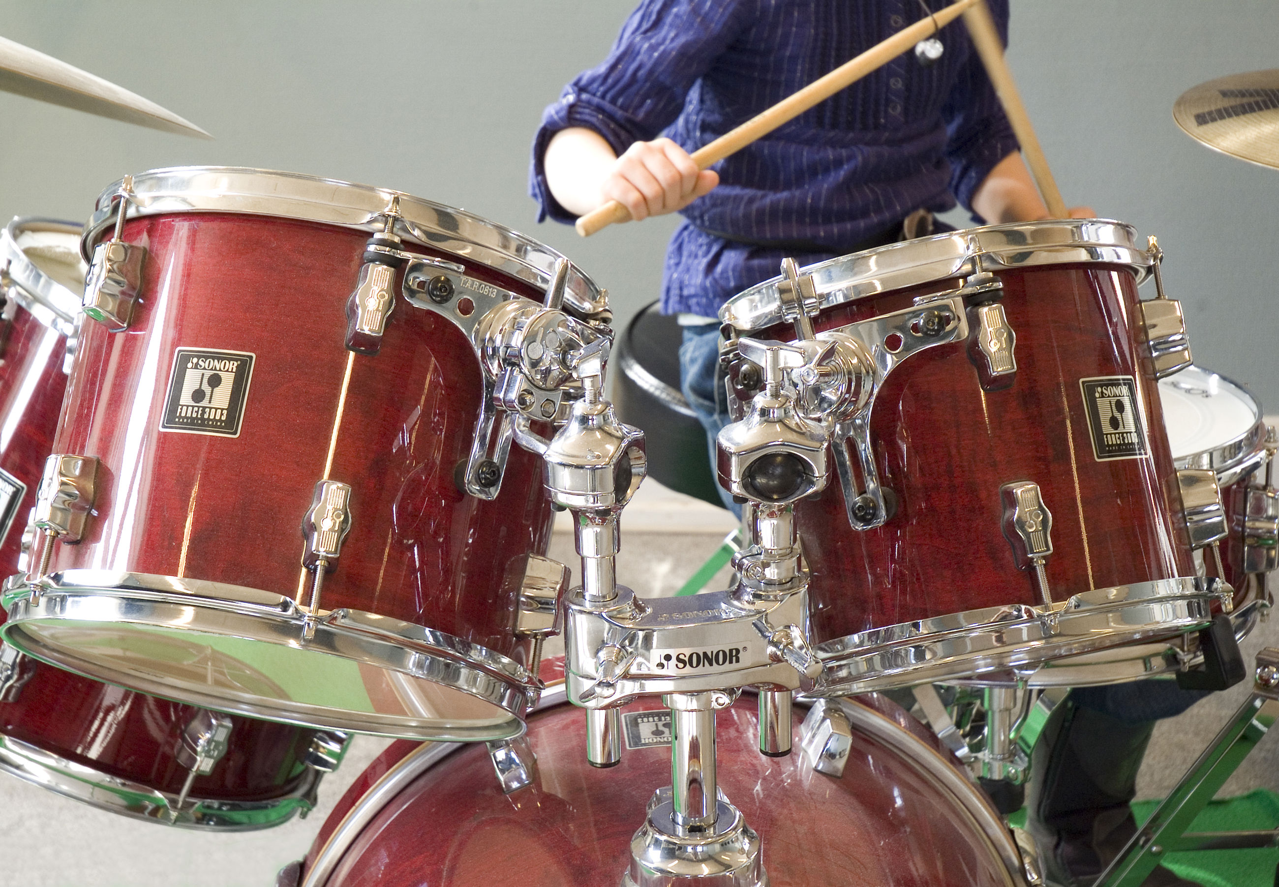 Dreng der spiller på et trommesæt